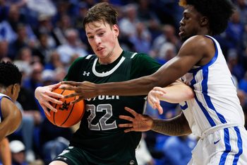 Nov 21, 2025; Lexington, Kentucky, USA; Loyola (MD) Greyhounds forward Sam Springer (22) drives to the basket against Kentucky Wildcats guard Kam Williams (3) during the first half at Rupp Arena at Central Bank Center. Mandatory Credit: Jordan Prather-Imagn Images