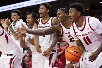 Nov 21, 2025; Fayetteville, Arkansas, USA; Arkansas Razorbacks forward Malique Ewin (12) guards D.J. wagner (21) Meleek Thomas (1) forward Nick Pringle (23) and wing Karter Knox (11) celebrate after a score in the second half against the Jackson State Tigers at Bud Walton Arena. Arkansas won 115-61. Mandatory Credit: Nelson Chenault-Imagn Images