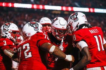Nov 21, 2025; Raleigh, North Carolina, USA;  NC State Wolfpack tight end Justin Joly (7) celebrates his touchdown to win the game during the second half of the game against Florida State Seminoles at Carter-Finley Stadium. Mandatory Credit: Jaylynn Nash-Imagn Images