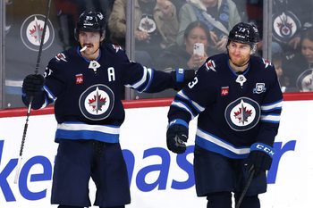 Nov 21, 2025; Winnipeg, Manitoba, CAN; Winnipeg Jets center Gabriel Vilardi (13) celebrates scoring against the Carolina Hurricanes with center Mark Scheifele (55) in the first period at Canada Life Centre. Mandatory Credit: James Carey Lauder-Imagn Images