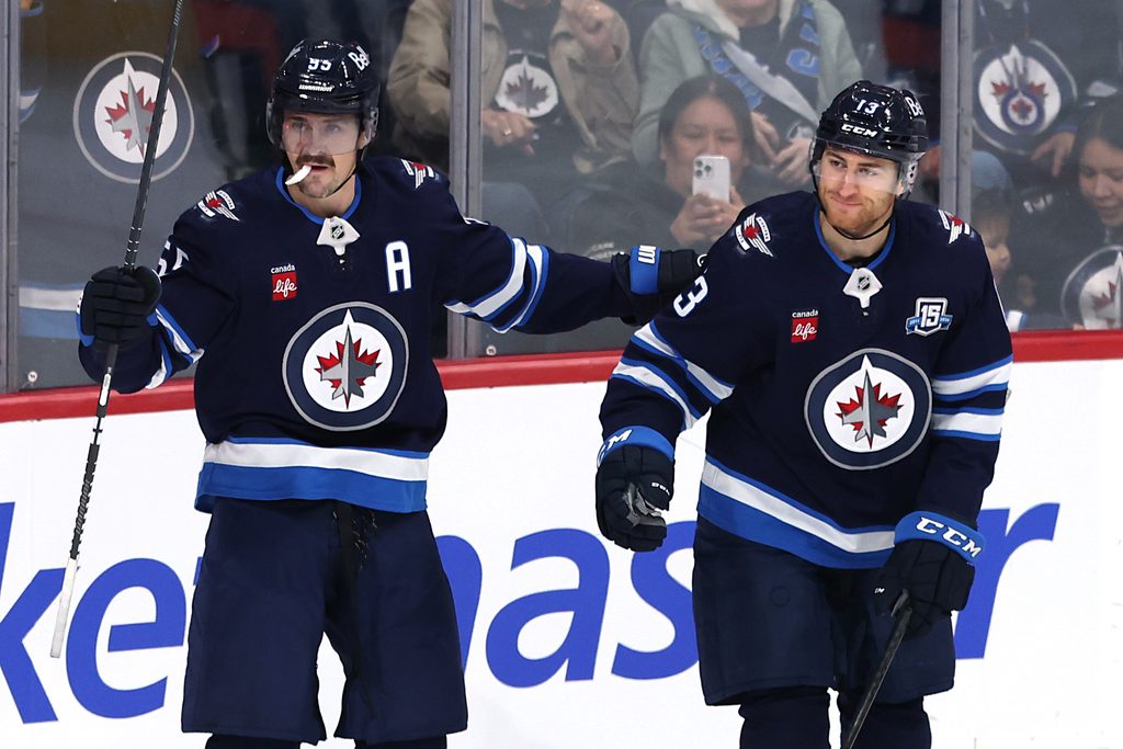 Nov 21, 2025; Winnipeg, Manitoba, CAN; Winnipeg Jets center Gabriel Vilardi (13) celebrates scoring against the Carolina Hurricanes with center Mark Scheifele (55) in the first period at Canada Life Centre. Mandatory Credit: James Carey Lauder-Imagn Images