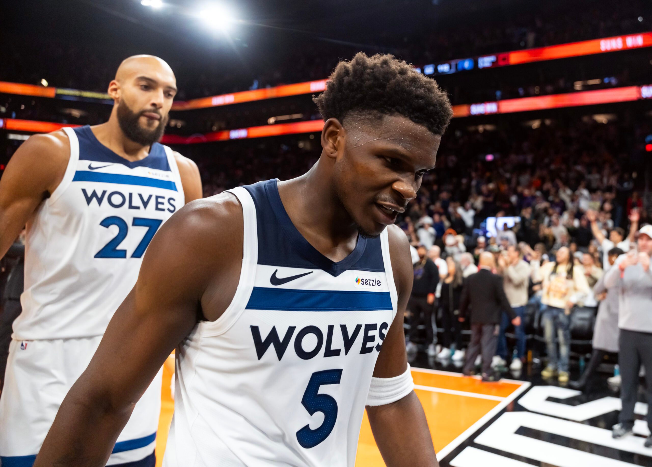 Nov 21, 2025; Phoenix, Arizona, USA; Minnesota Timberwolves guard Anthony Edwards (5) and center Rudy Gobert (27) react as they walk off the court after losing to the Phoenix Suns in the second half of an NBA Cup game at Mortgage Matchup Center. Mandatory Credit: Mark J. Rebilas-Imagn Images