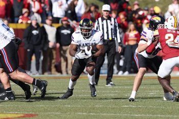 Nov 22, 2025; Ames, Iowa, USA; Kansas Jayhawks running back Daniel Hishaw Jr. (9) runs the football against the Iowa State Cyclones during the first half at Jack Trice Stadium. Mandatory Credit: Reese Strickland-Imagn Images