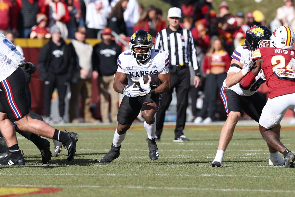 Nov 22, 2025; Ames, Iowa, USA; Kansas Jayhawks running back Daniel Hishaw Jr. (9) runs the football against the Iowa State Cyclones during the first half at Jack Trice Stadium. Mandatory Credit: Reese Strickland-Imagn Images