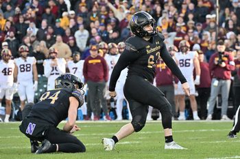 Nov 22, 2025; Chicago, Illinois, USA; Northwestern Wildcats kicker Jack Olsen (82) kicks the game winning field goal against the Minnesota Golden Gophers during the second half at Wrigley Field. Mandatory Credit: Patrick Gorski-Imagn Images