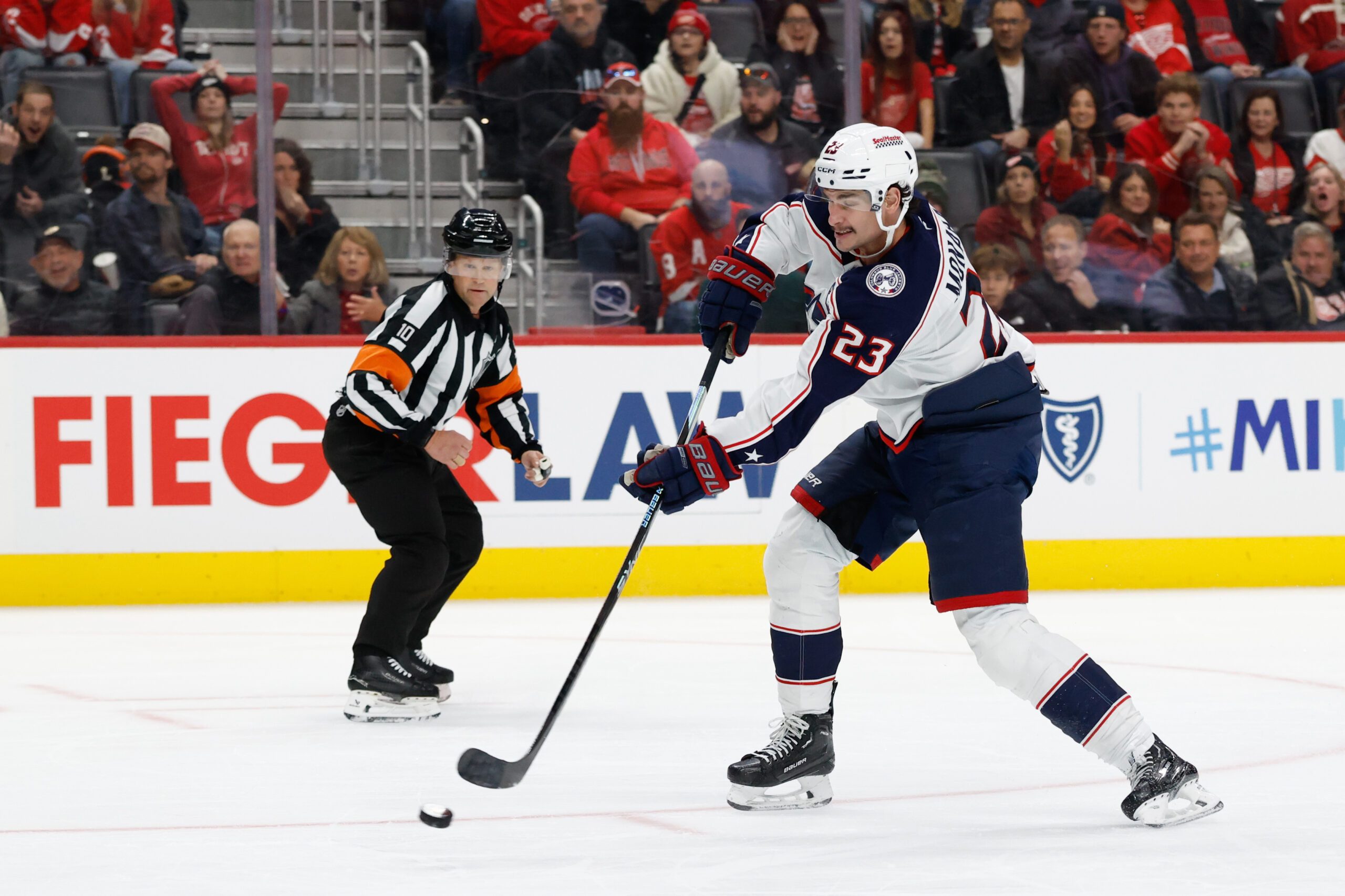 Nov 22, 2025; Detroit, Michigan, USA;  Columbus Blue Jackets center Sean Monahan (23) takes a shot in the third period against the Detroit Red Wings at Little Caesars Arena. Mandatory Credit: Rick Osentoski-Imagn Images