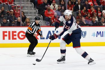 Nov 22, 2025; Detroit, Michigan, USA;  Columbus Blue Jackets center Sean Monahan (23) takes a shot in the third period against the Detroit Red Wings at Little Caesars Arena. Mandatory Credit: Rick Osentoski-Imagn Images