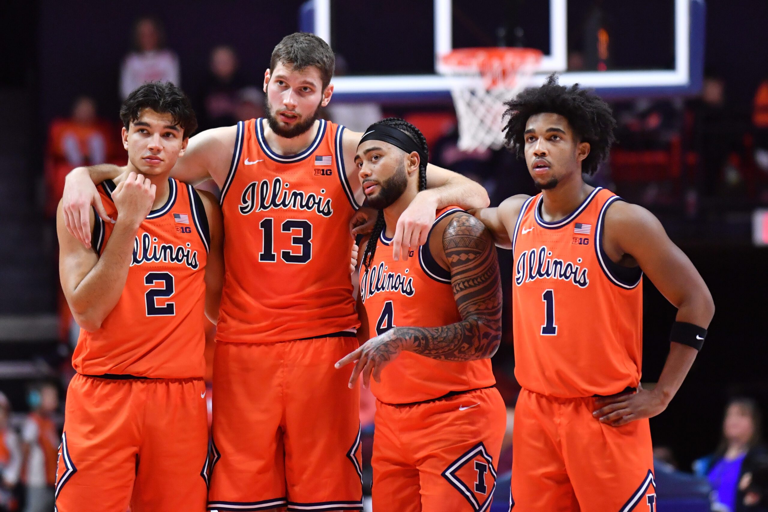 Nov 22, 2025; Champaign, Illinois, USA;  Illinois fighting Illini players  Andrej Stojakovic (2) Tomislav Ivisic (13)  guard Kylan Boswell (4) and Brandon Lee (1) stand while teammate  Ben Humrichhous (3) shoots for a technical foul on the Long Island University Sharks during the first half at State Farm Center. Mandatory Credit: Ron Johnson-Imagn Images