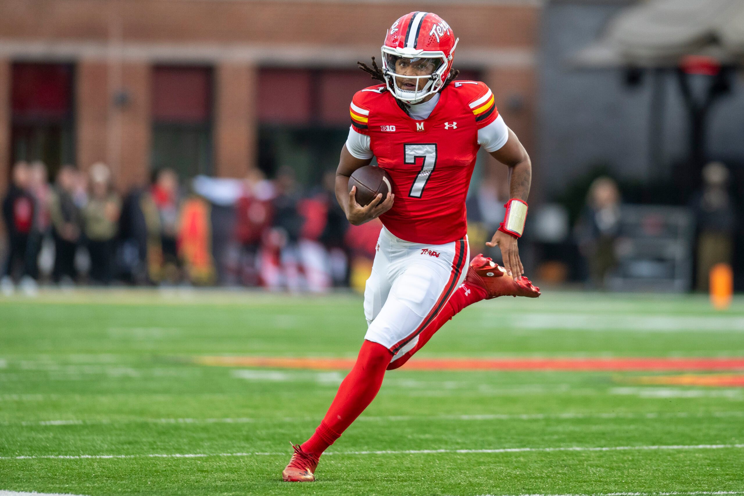 Nov 22, 2025; College Park, Maryland, USA;  Maryland Terrapins quarterback Malik Washington (7) scrambles during the first quarter against the Michigan Wolverines at SECU Stadium. Mandatory Credit: Tommy Gilligan-Imagn Images