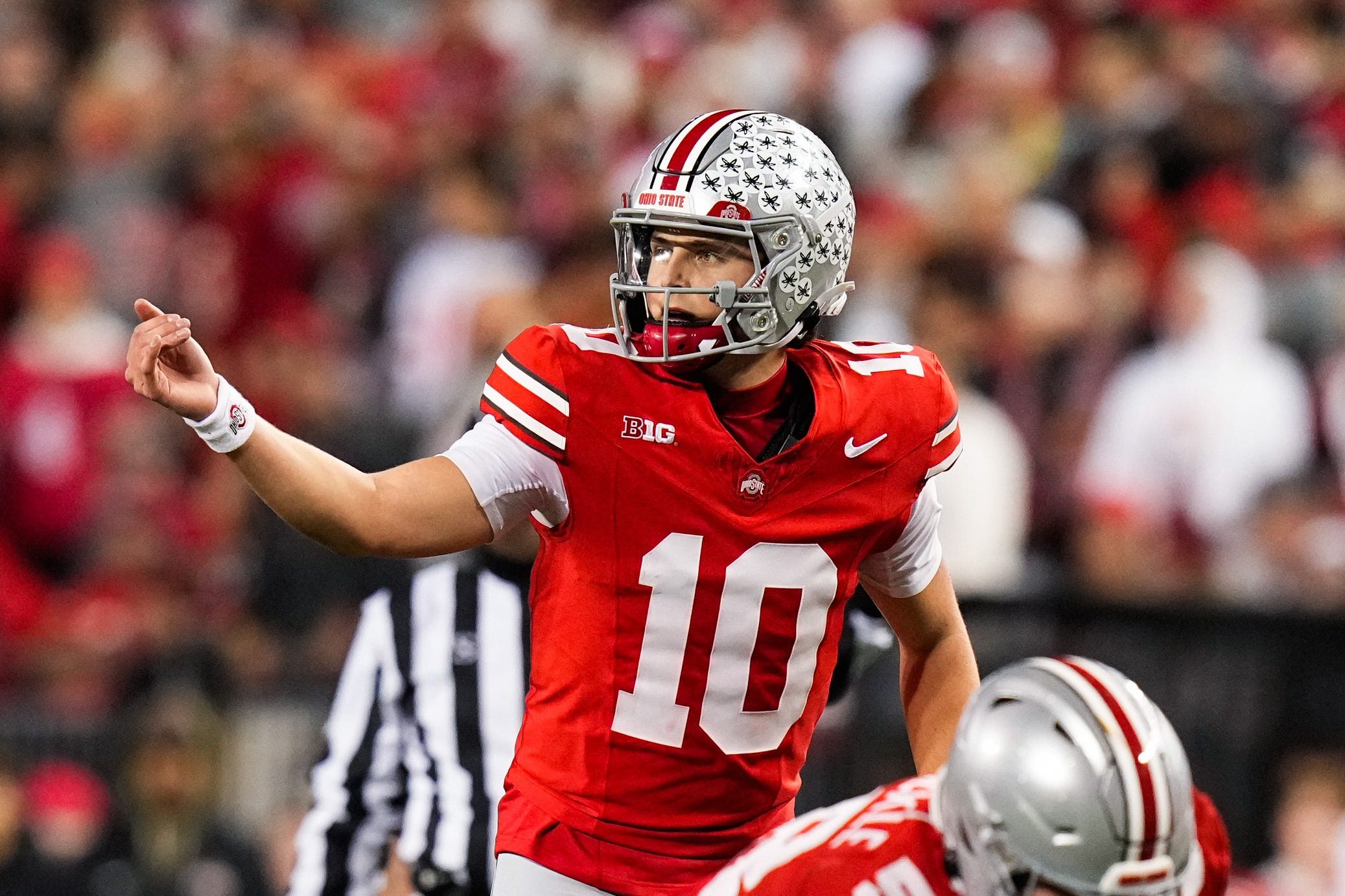 Ohio State Buckeyes quarterback Julian Sayin (10) speaks to his teammates in the second half of the NCAA college football game at Ohio Stadium on Saturday, Nov. 15, 2025 in Columbus, Ohio.