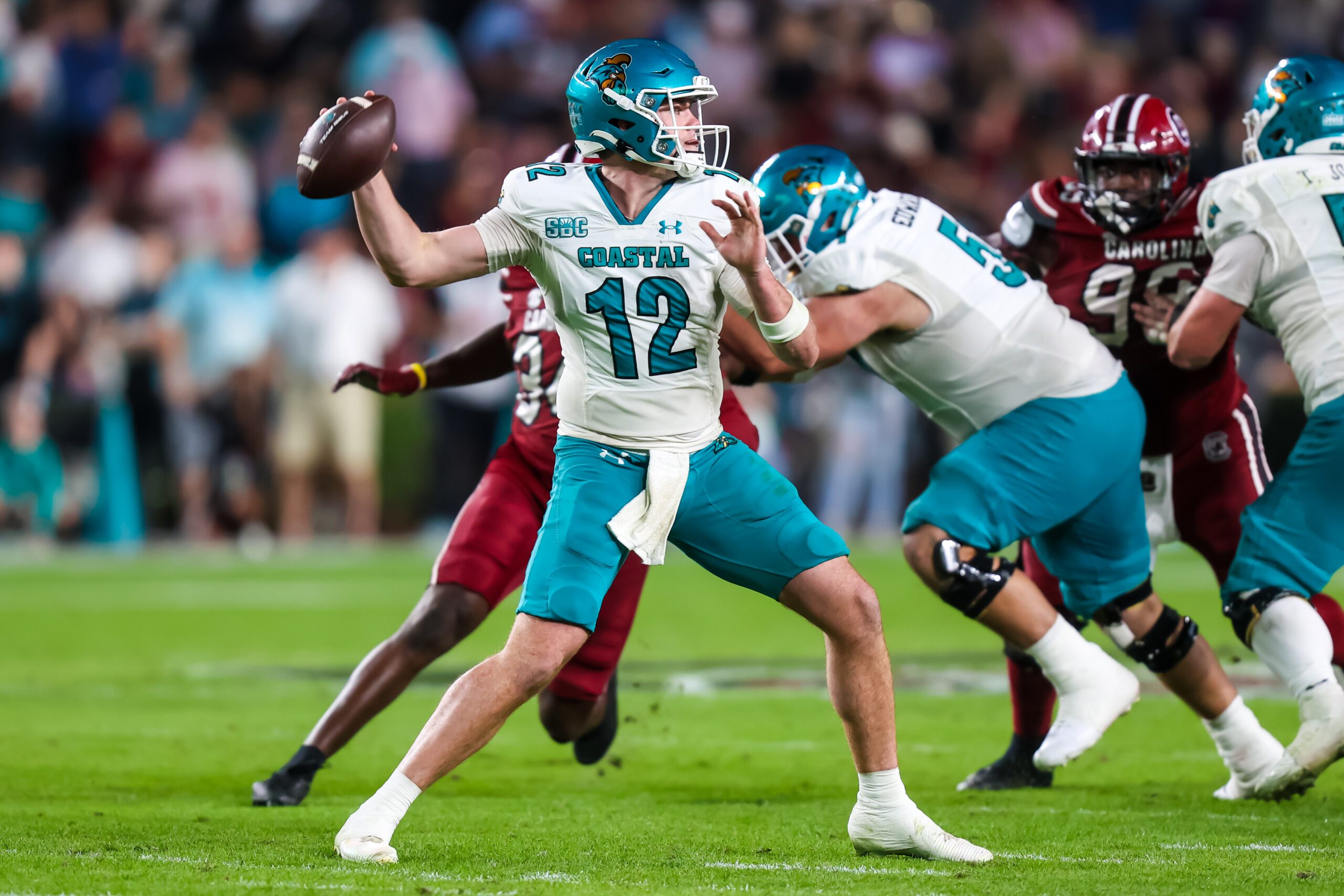 Nov 22, 2025; Columbia, South Carolina, USA; Coastal Carolina Chanticleers quarterback Tad Hudson (12) passes against the South Carolina Gamecocks in the second half at Williams-Brice Stadium. Mandatory Credit: Jeff Blake-Imagn Images