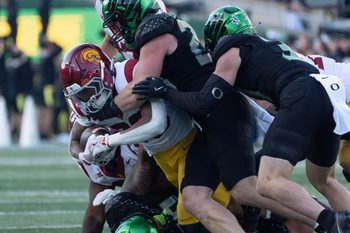 The Oregon defense piles up Southern California running back King Miller during the second half Nov. 22, 2025.