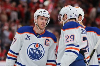 Nov 22, 2025; Sunrise, Florida, USA; Edmonton Oilers center Connor McDavid (97) speaks to center Leon Draisaitl (29) against the Florida Panthers during the second period at Amerant Bank Arena. Mandatory Credit: Sam Navarro-Imagn Images