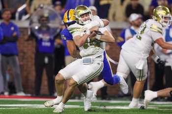 Nov 22, 2025; Atlanta, Georgia, USA; Georgia Tech Yellow Jackets quarterback Haynes King (10) is tackled by Pittsburgh Panthers defensive lineman Joey Zelinsky (45) in the third quarter at Bobby Dodd Stadium at Hyundai Field. Mandatory Credit: Brett Davis-Imagn Images