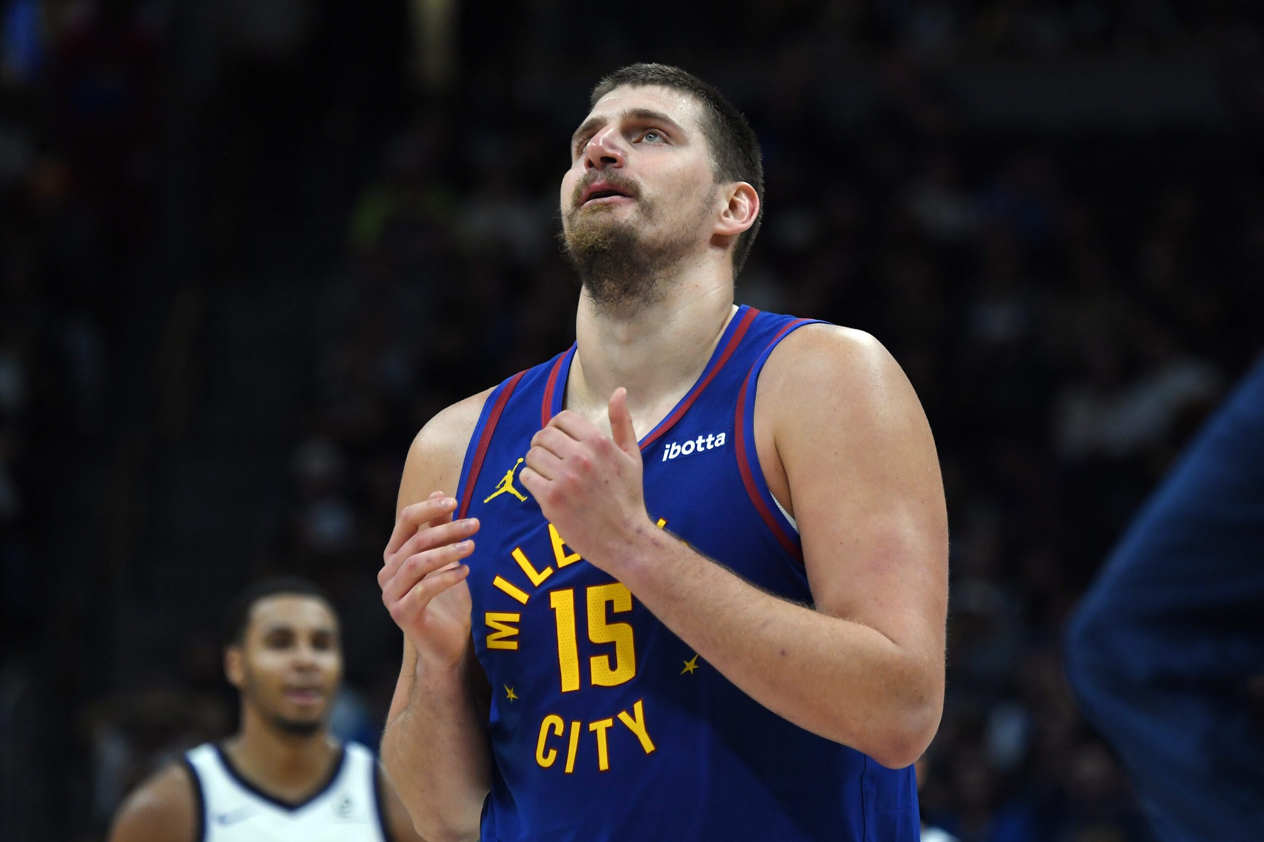 Nov 22, 2025; Denver, Colorado, USA; Denver Nuggets center Nikola Jokic (15) walks back to the bench during a timeout while trailing during the second half against the Sacramento Kings at Ball Arena. Mandatory Credit: Christopher Hanewinckel-Imagn Images