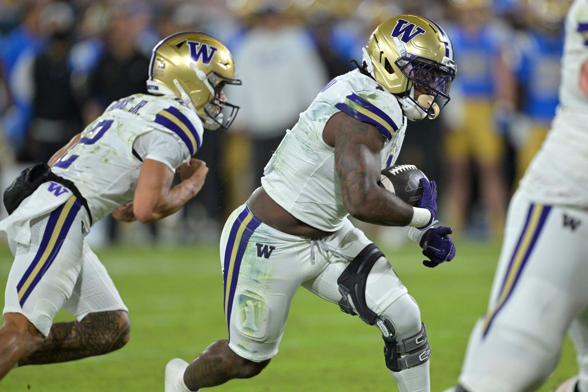 Nov 22, 2025; Pasadena, California, USA; Washington Huskies quarterback Demond Williams Jr. (2) hands off to running back Jonah Coleman (1) who runs for a touchdown in the second half against the UCLA Bruins at the Rose Bowl. Mandatory Credit: Jayne Kamin-Oncea-Imagn Images