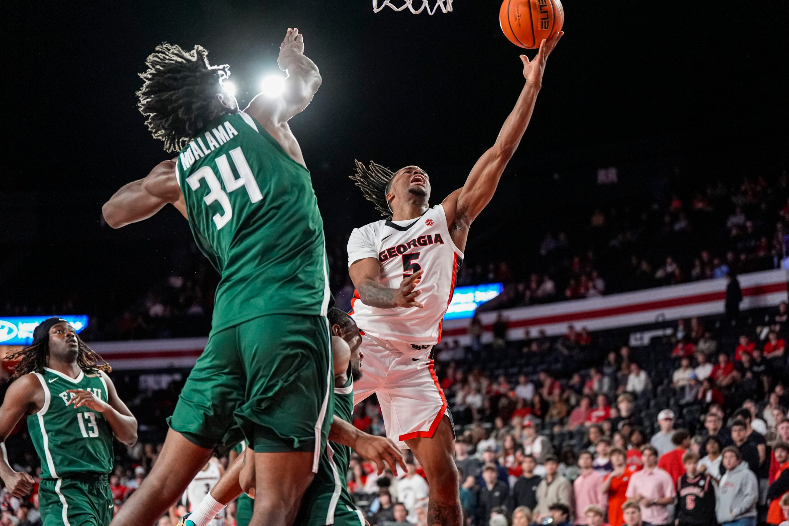Nov 17, 2025; Athens, Georgia, USA; Georgia Bulldogs guard Jeremiah Wilkinson (5) shoots over Florida A&M Rattlers center Miles Ndalama (34) at Stegeman Coliseum. Mandatory Credit: Dale Zanine-Imagn Images