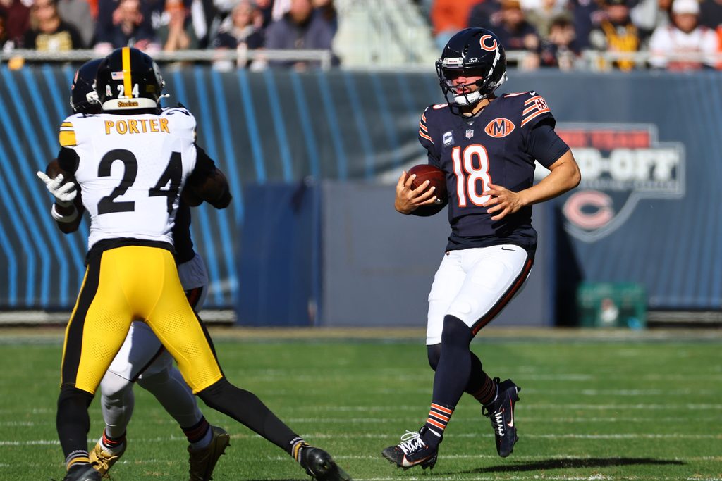 Nov 23, 2025; Chicago, Illinois, USA; Chicago Bears quarterback Caleb Williams (18) rushes the ball against the Pittsburgh Steelers during the first half at Soldier Field. Mandatory Credit: Mike Dinovo-Imagn Images
