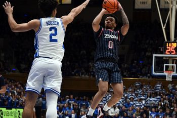 Nov 23, 2025; Durham, North Carolina, USA;  Howard Bison guard Isaiah Brown (0) shoots over Duke Blue Devils guard Cayden Boozer (2) during the first half at Cameron Indoor Stadium. Mandatory Credit: Rob Kinnan-Imagn Images