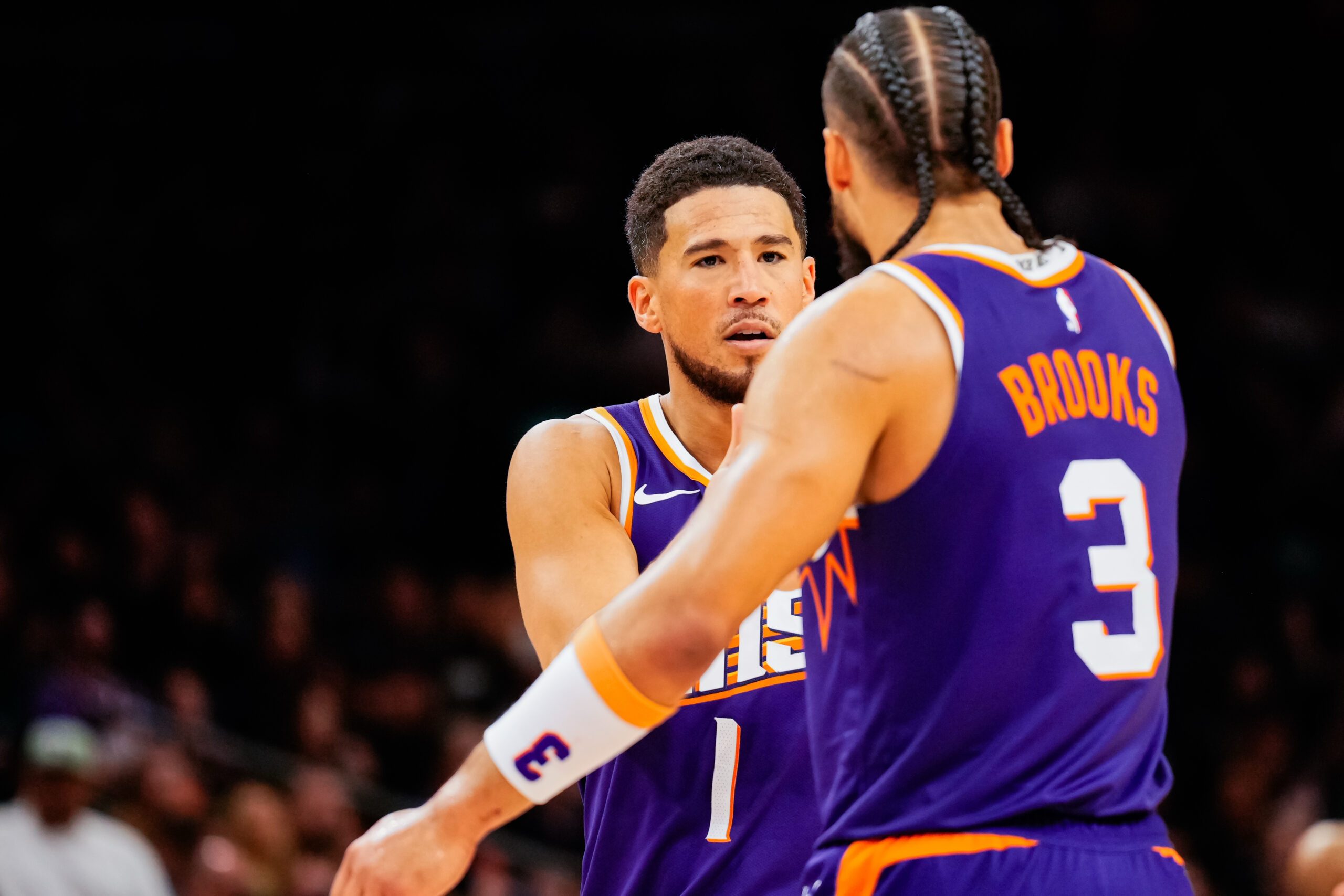Nov 23, 2025; Phoenix, Arizona, USA; Phoenix Suns guard Devin Booker (1) and Dillon Brooks (3) high five in the second half of the game at Mortgage Match Up Center. Mandatory Credit: Arianna Grainey-Imagn Images