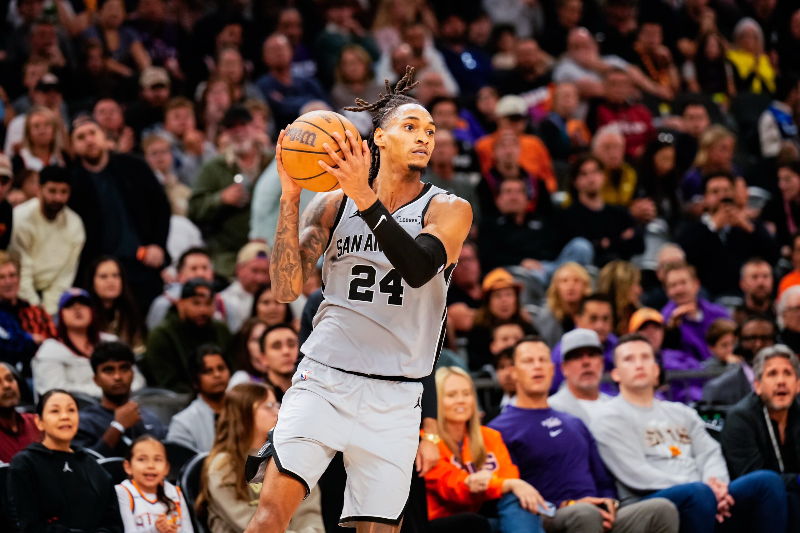 Nov 23, 2025; Phoenix, Arizona, USA; San Antonio Spurs guard Devin Vassell (24) grabs a pass in the second half of the game at Mortgage Match Up Center. Mandatory Credit: Arianna Grainey-Imagn Images