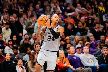 Nov 23, 2025; Phoenix, Arizona, USA; San Antonio Spurs guard Devin Vassell (24) grabs a pass in the second half of the game at Mortgage Match Up Center. Mandatory Credit: Arianna Grainey-Imagn Images