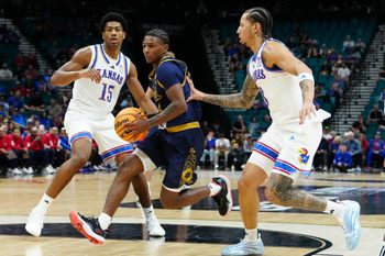 Nov 24, 2025; Las Vegas, Nevada, USA; Notre Dame Fighting Irish guard Markus Burton (3) drives the lane on Kansas Jayhawks forward Bryson Tiller (15) during the second half in a 2025 Players Era Festival group play game at MGM Grand Garden Arena. Mandatory Credit: Stephen R. Sylvanie-Imagn Images