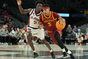 Nov 24, 2025; Las Vegas, Nevada, USA; Iowa State Cyclones guard Tamin Lipsey (3) drives to the hoop past St. John's Red Storm guard Joson Sanon (3) during the second half in a 2025 Players Era Festival group play game at Michelob Ultra Arena. Mandatory Credit: Kirby Lee-Imagn Images