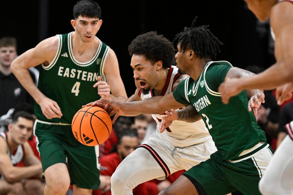 Nov 24, 2025; Louisville, Kentucky, USA; (Editors Notes: Caption Correction) Louisville Cardinals guard J'Vonne Hadley (1) dribbles against Eastern Michigan Eagles guard Carlos Hart (2) during the first half at KFC Yum! Center. Mandatory Credit: Jamie Rhodes-Imagn Images