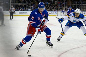 Nov 24, 2025; New York, New York, USA; New York Rangers left wing Artemi Panarin (10) plays the puck defended by St. Louis Blues center Brayden Schenn (10) during the second period at Madison Square Garden. Mandatory Credit: Dennis Schneidler-Imagn Images