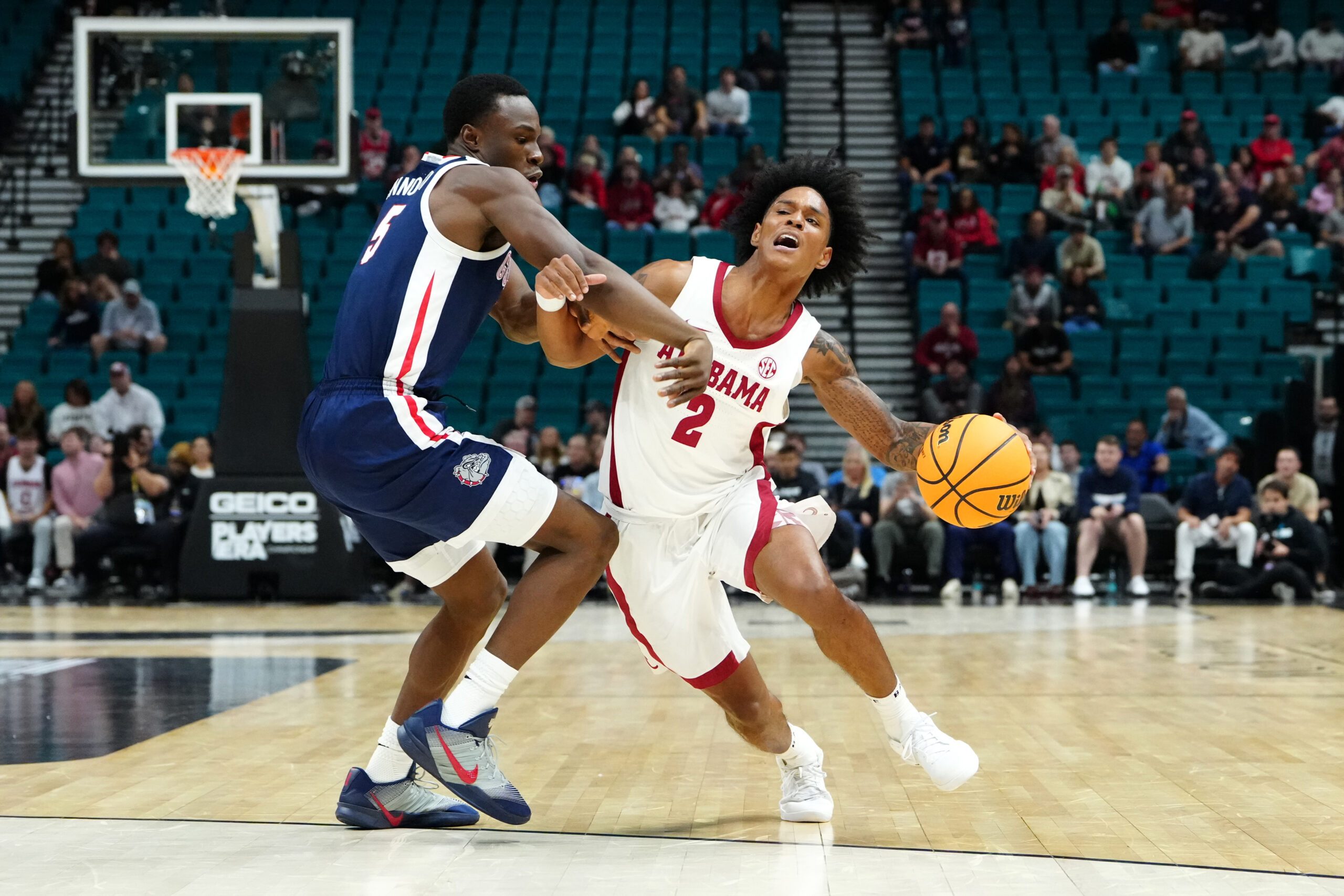 Nov 24, 2025; Las Vegas, Nevada, USA; Alabama Crimson Tide guard Aden Holloway (2) controls the ball against Gonzaga Bulldogs forward Emmanuel Innocenti (5) during the first half in a 2025 Players Era Festival group play game at MGM Grand Garden Arena. Mandatory Credit: Stephen R. Sylvanie-Imagn Images