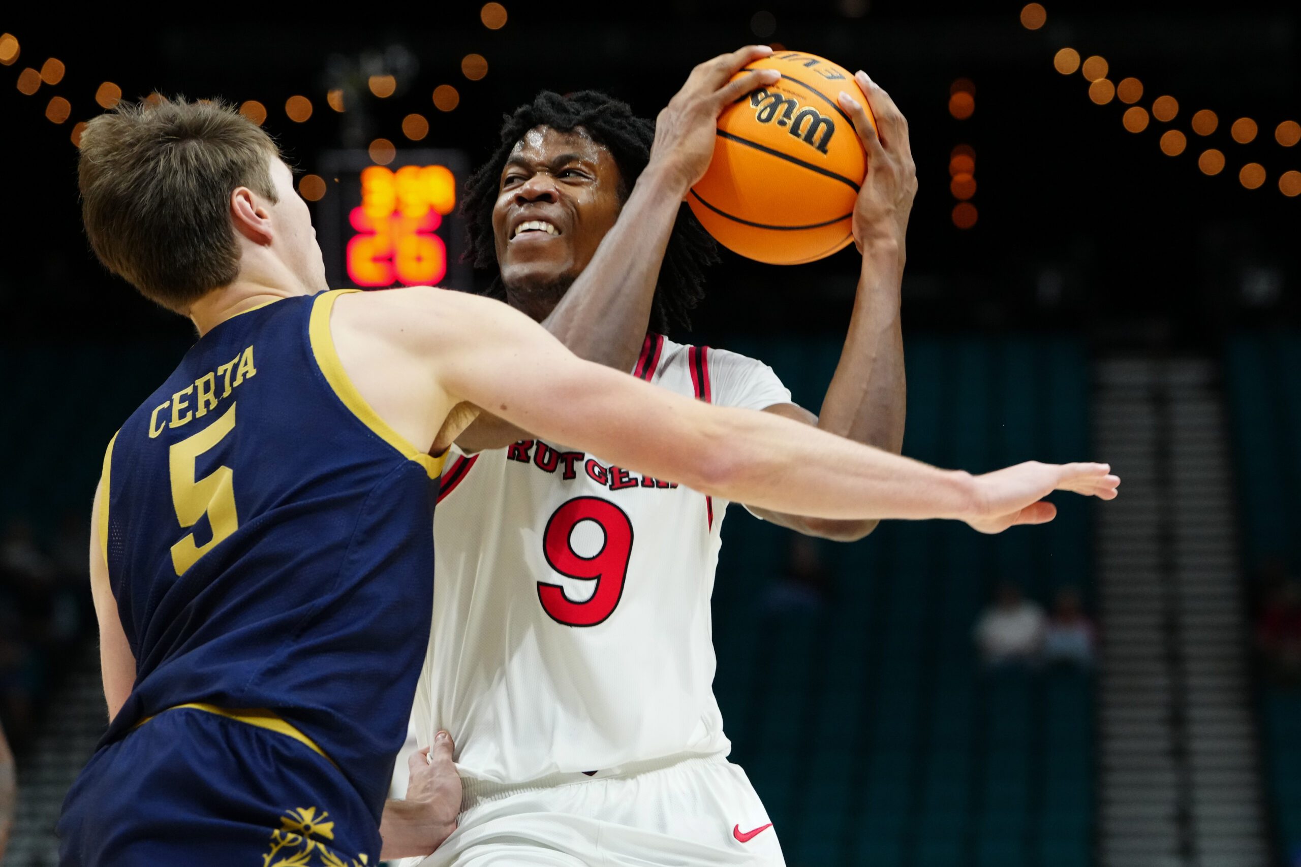 Nov 25, 2025; Las Vegas, Nevada, USA; Notre Dame Fighting Irish guard Cole Certa (5) defends against Rutgers Scarlet Knights forward Dylan Grant (9) during the first half in a 2025 Players Era Festival group play game at MGM Grand Garden Arena. Mandatory Credit: Stephen R. Sylvanie-Imagn Images