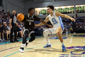 Nov 25, 2025; Fort Myers, Florida, USA; St. Bonaventure Bonnies guard Darryl Simmons II (8) is guarded by North Carolina Tar Heels guard Luka Bogavac (44) in the second half at Suncoast Credit Union Arena. Mandatory Credit: Nathan Ray Seebeck-Imagn Images