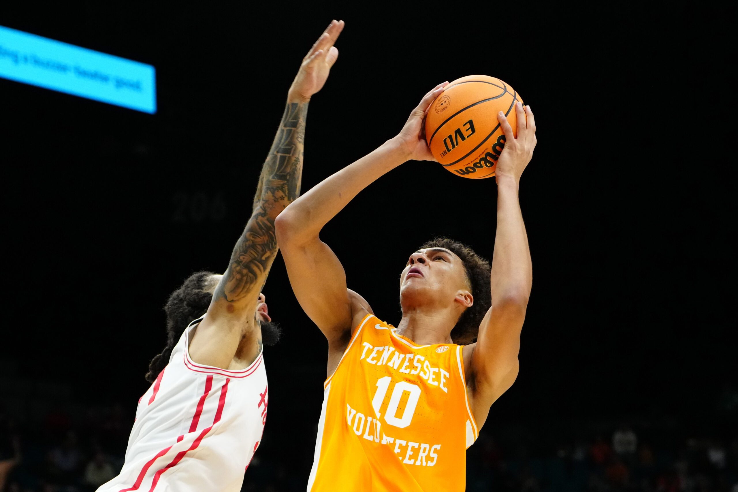 Nov 25, 2025; Las Vegas, NV, USA; Tennessee Volunteers forward Nate Ament (10) drives to the basket against Houston Cougars guard Emanuel Sharp (21) in a 2025 Players Era Festival group play game during the second half at MGM Grand Garden Arena. Mandatory Credit: Stephen R. Sylvanie-Imagn Images