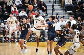 UW-Milwaukee guard Amar Augillard (1) goes to the basket past Dominican forward Frank Paszkowski (22) and Dominican guard/forward Dominic Crapia (14) in a game Tuesday, November 25, 2025, at the Klotsche Center in Milwaukee, Wisconsin.