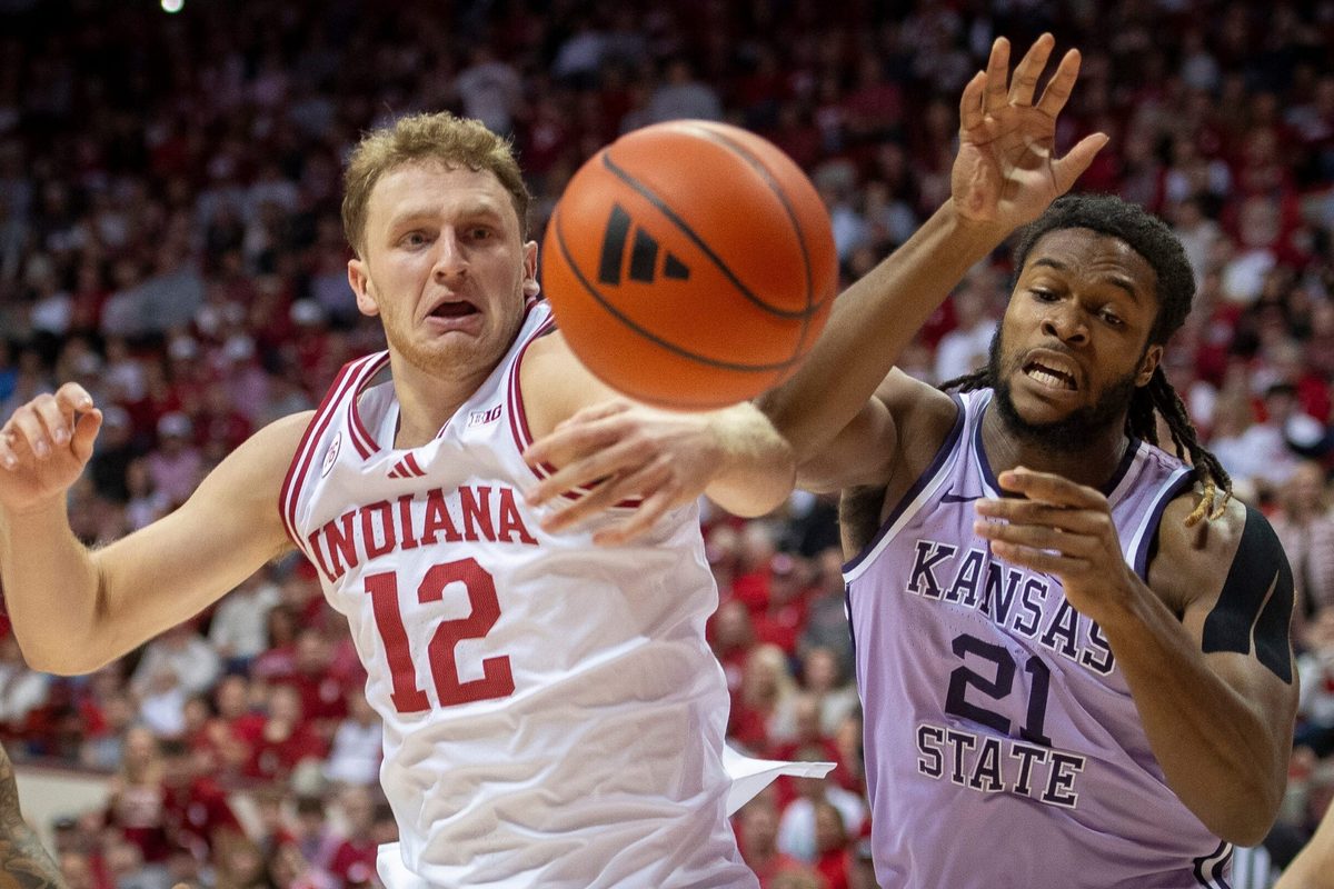 Indiana's Tucker DeVries (12) and Kansas State's Khamari McGriff (21) go for a rebound during the Indiana versus Kansas State men's basketball game at Simon Skjodt Assembly Hall on Tuesday, Nov. 25, 2025.