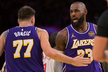 Nov 25, 2025; Los Angeles, California, USA;  Los Angeles Lakers guard Luka Doncic (77) and forward LeBron James (23) react after a foul during the first half against the Los Angeles Clippers at Crypto.com Arena. Mandatory Credit: Jayne Kamin-Oncea-Imagn Images