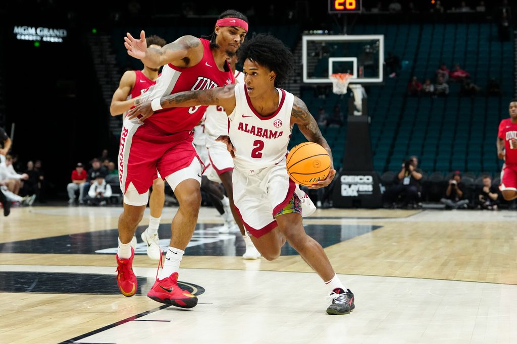Nov 25, 2025; Las Vegas, Nevada, USA; Alabama Crimson Tide guard Aden Holloway (2) drives the ball in the first half against UNLV Rebels in a 2025 Players Era Festival group play game at MGM Grand Garden Arena. Mandatory Credit: Stephen R. Sylvanie-Imagn Images