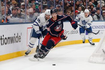 Nov 26, 2025; Columbus, Ohio, USA; Columbus Blue Jackets defenseman Zach Werenski (8) carries the puck as Toronto Maple Leafs center Nicolas Roy (55) trails the play during the first period at Nationwide Arena. Mandatory Credit: Russell LaBounty-Imagn Images