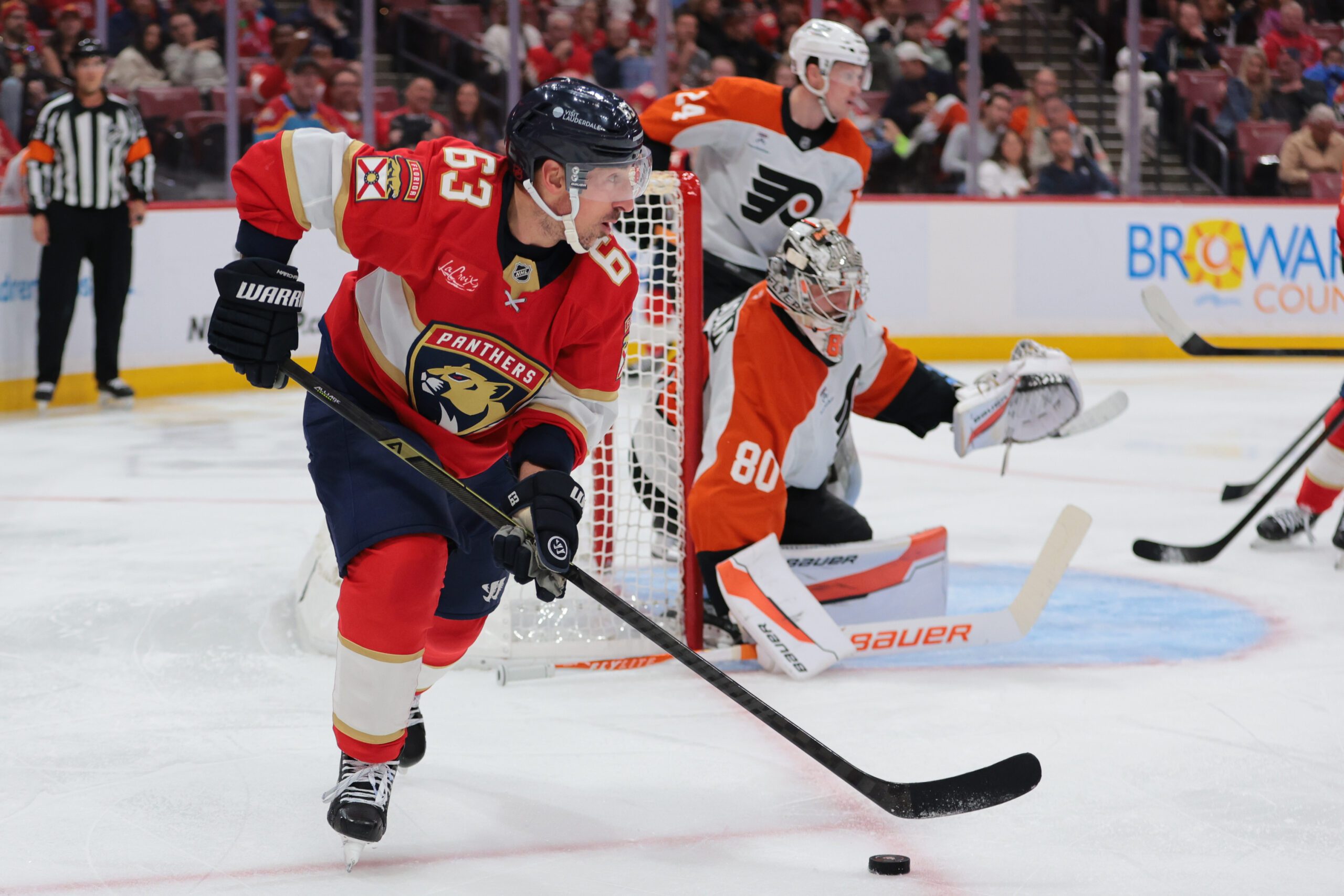 Nov 26, 2025; Sunrise, Florida, USA; Florida Panthers left wing Brad Marchand (63) moves the puck against the Philadelphia Flyers during the second period at Amerant Bank Arena. Mandatory Credit: Sam Navarro-Imagn Images
