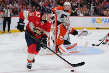 Nov 26, 2025; Sunrise, Florida, USA; Florida Panthers left wing Brad Marchand (63) moves the puck against the Philadelphia Flyers during the second period at Amerant Bank Arena. Mandatory Credit: Sam Navarro-Imagn Images