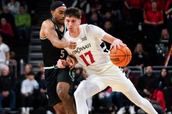 Cincinnati Bearcats guard Jordi Rodriguez (17) drives the ball past Eastern Michigan Eagles guard Braelon Green (5) in the second half of a NCAA men’s basketball game between the Cincinnati Bearcats and Eastern Michigan Eagles, Wednesday, Nov. 26, 2025, at Fifth Third Arena in Cincinnati. Eagles won 64-56.