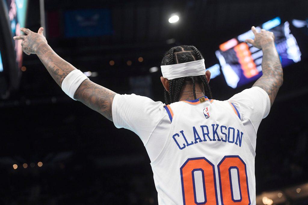 Nov 26, 2025; Charlotte, North Carolina, USA; New York Knicks guard Jordan Clarkson (00) reacts after his team scores during the second half against the Charlotte Hornets at the Spectrum Center. Mandatory Credit: Sam Sharpe-Imagn Images
