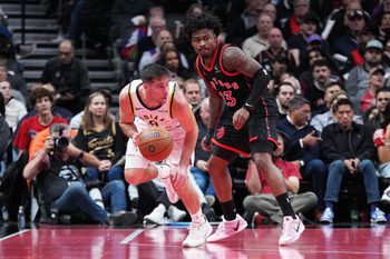 Nov 26, 2025; Toronto, Ontario, CAN; Indiana Pacers guard T.J. McConnell (9) controls the ball as Toronto Raptors guard Jamal Shead (23) tries to defend during the fourth quarter at Scotiabank Arena. Mandatory Credit: Nick Turchiaro-Imagn Images