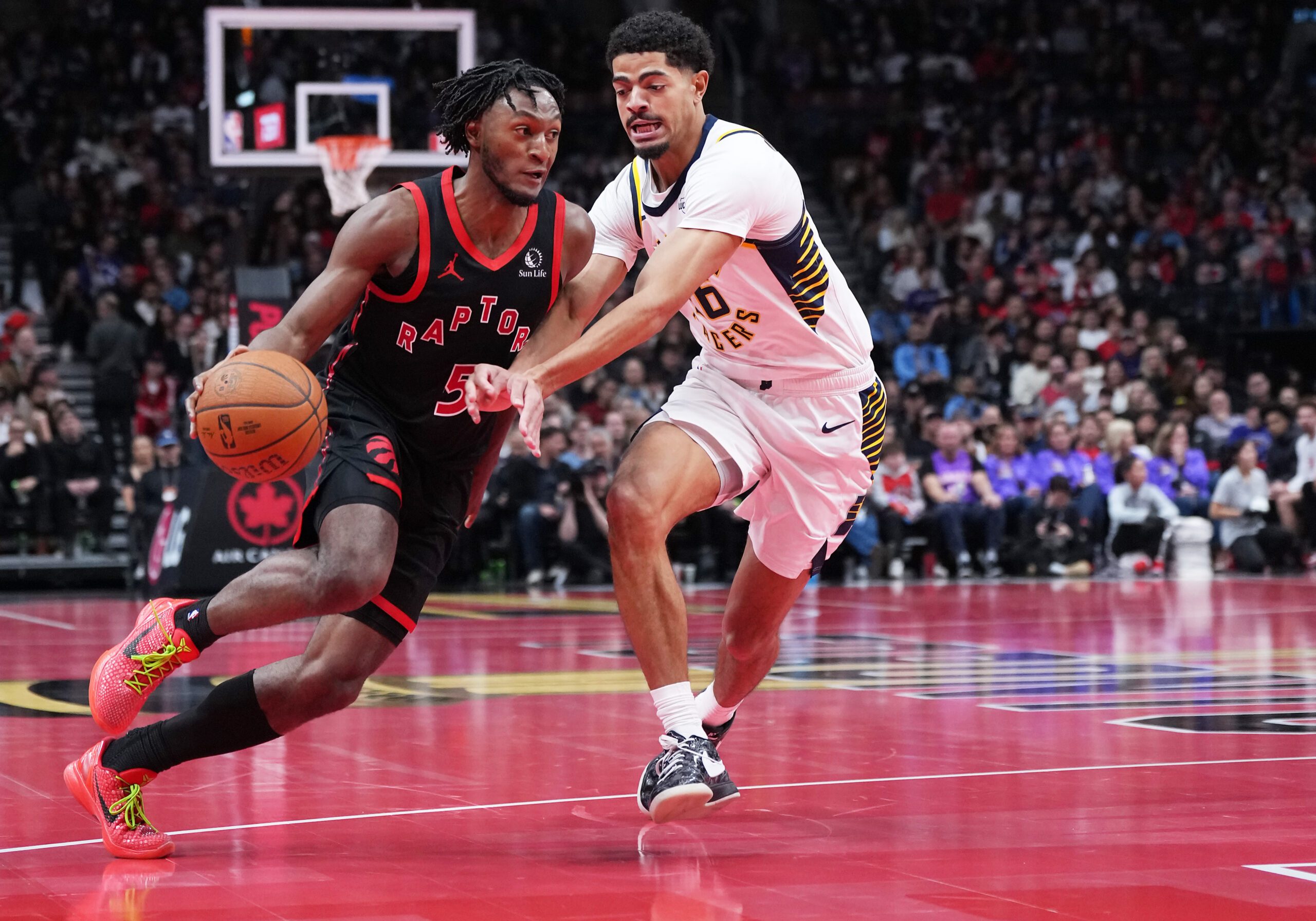 Nov 26, 2025; Toronto, Ontario, CAN; Toronto Raptors guard Immanuel Quickley (5) controls the ball as Indiana Pacers guard Ben Sheppard (26) tries to defend during the third quarter at Scotiabank Arena. Mandatory Credit: Nick Turchiaro-Imagn Images
