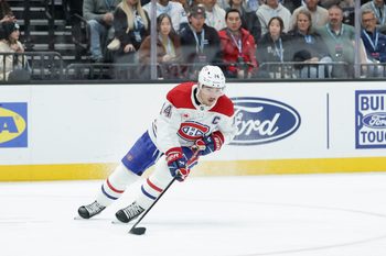 Nov 26, 2025; Salt Lake City, Utah, USA; Montreal Canadiens center Nick Suzuki (14) controls the puck during the third period against the Utah Mammoth at Delta Center. Mandatory Credit: Chris Nicoll-Imagn Images