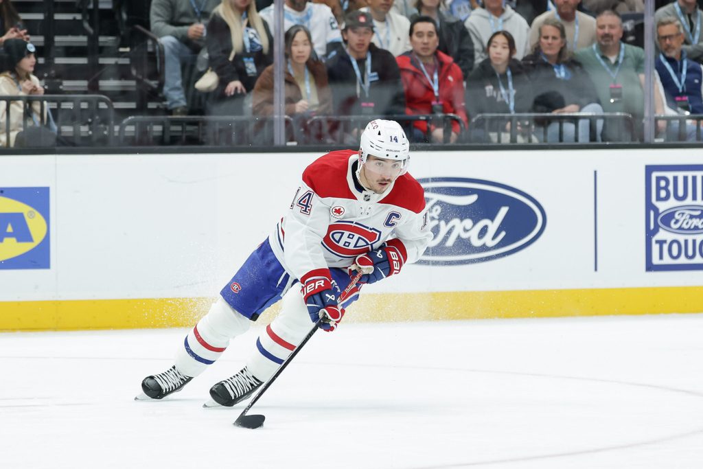 Nov 26, 2025; Salt Lake City, Utah, USA; Montreal Canadiens center Nick Suzuki (14) controls the puck during the third period against the Utah Mammoth at Delta Center. Mandatory Credit: Chris Nicoll-Imagn Images