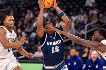 Nevada Wolf Pack guard Tayshawn Comer (12) fights through traffic on the way to the hoop during the first half of their game in the Acrisure Series in Palm Desert, Calif., Thursday, Nov. 27, 2025.
