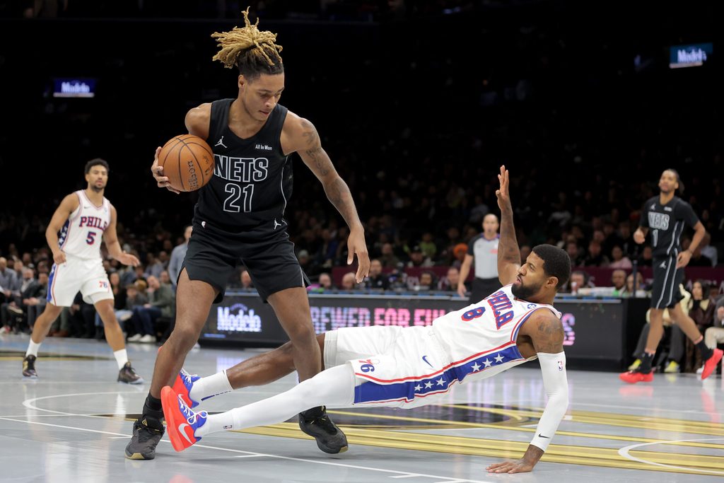 Nov 28, 2025; Brooklyn, New York, USA; Brooklyn Nets forward Noah Clowney (21) controls the ball against Philadelphia 76ers forward Paul George (8) during the third quarter at Barclays Center. Mandatory Credit: Brad Penner-Imagn Images