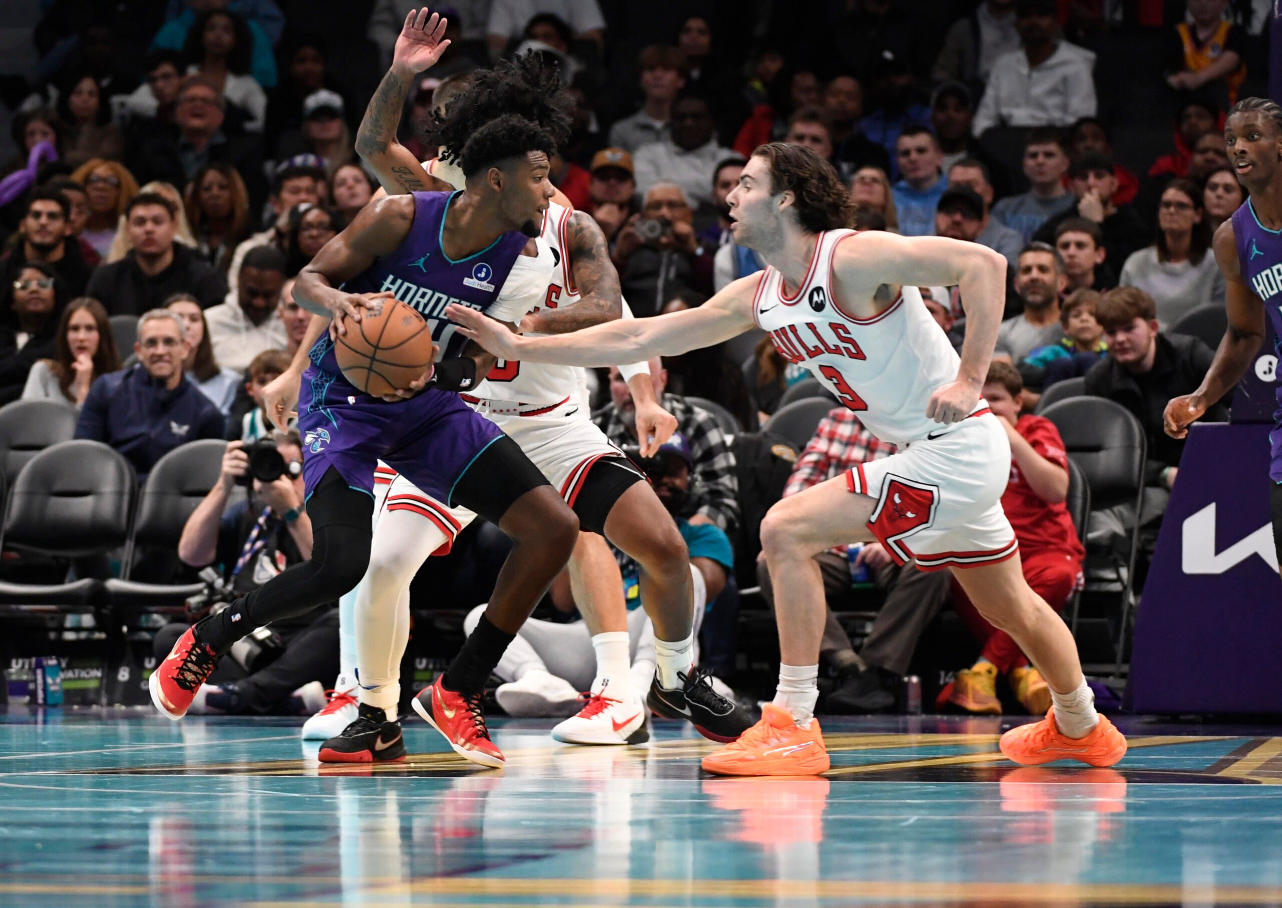 Nov 28, 2025; Charlotte, North Carolina, USA; Charlotte Hornets forward Brandon Miller (24) looks to drive in as he is defended by Chicago Bulls guard Josh Giddey (3) during the second half at the Spectrum Center. Mandatory Credit: Sam Sharpe-Imagn Images